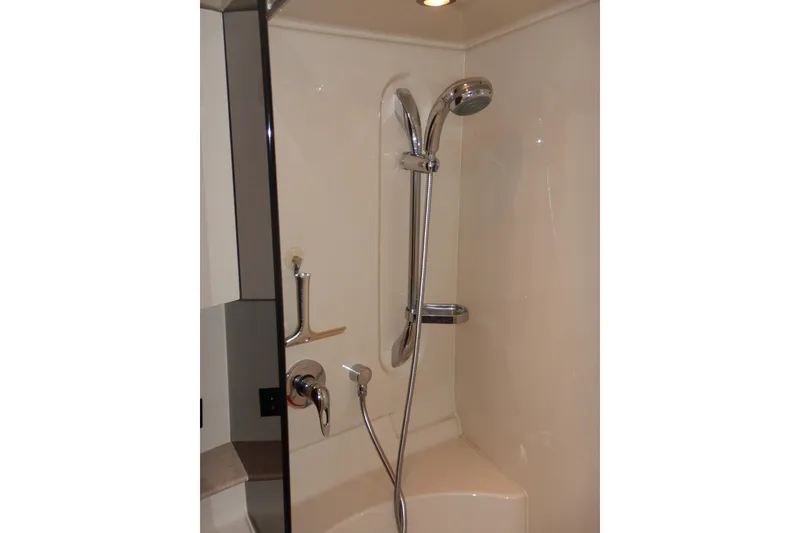 Slide: The Image of 2007 Cruisers 340 Express engine room with fire extinguisher and 12V battery charger. - 47