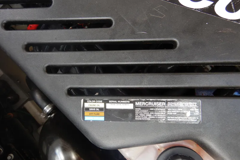 Slide: The Image of Engine compartment of a 2007 Cruisers 340 Express boat, featuring hoses and mechanical components. - 49