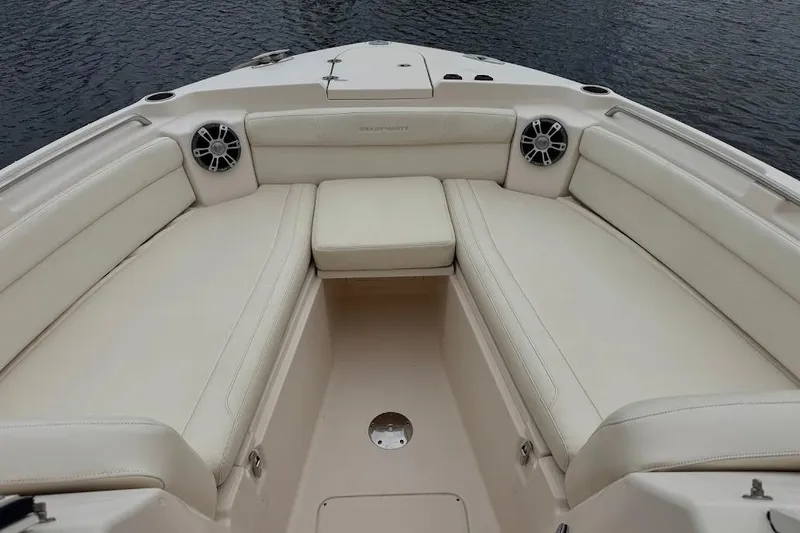 Slide: The Image of 2020 Grady-White Freedom 285 boat interior with cushioned seating and speakers. - 17