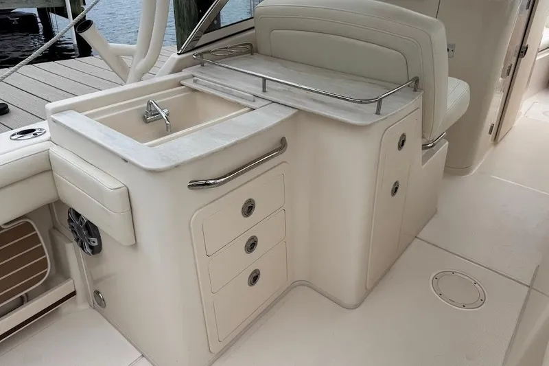 Slide: The Image of 2020 Grady-White Freedom 285 boat interior with sink and storage drawers. - 25