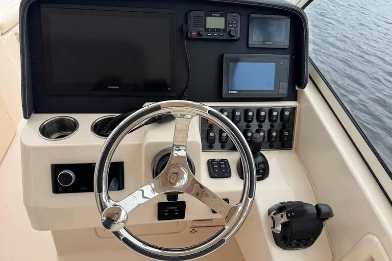 Slide: The Image of 2020 Grady-White Freedom 285 helm with steering wheel, controls, and navigation screens. - 30