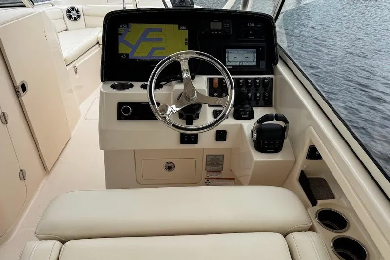 Slide: The Image of 2020 Grady-White Freedom 285 boat helm with modern navigation system and controls. - 31