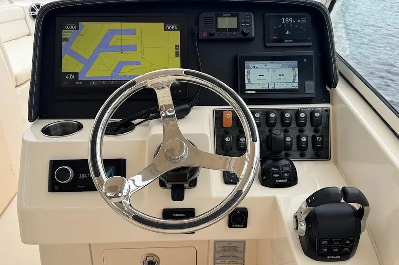Slide: The Image of 2020 Grady-White Freedom 285 helm with navigation screens and controls. - 32