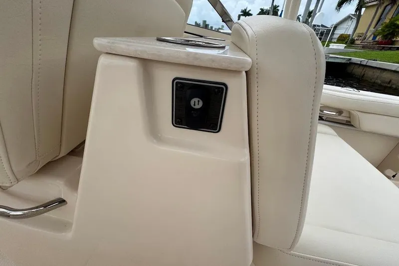 Slide: The Image of 2020 Grady-White Freedom 285 boat interior with beige seating and cup holder. - 35
