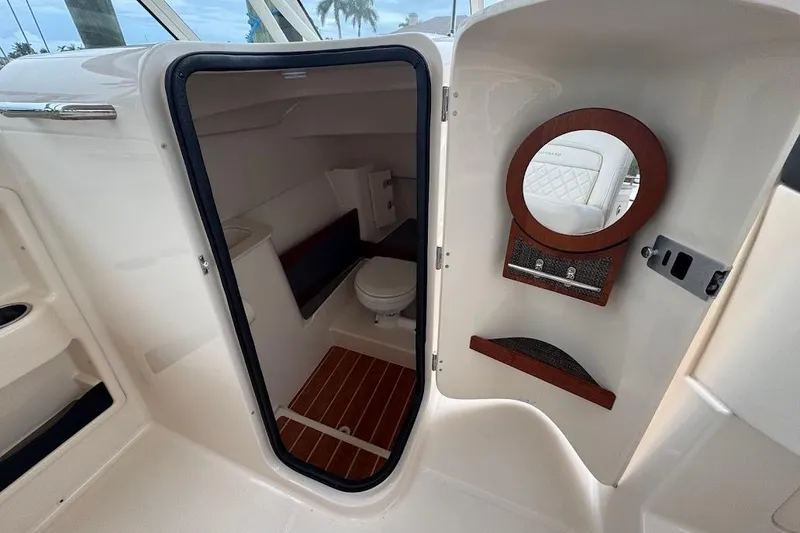 Slide: The Image of 2020 Grady-White Freedom 285 boat interior with a compact bathroom and mirror. - 37