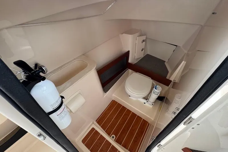 Slide: The Image of 2020 Grady-White Freedom 285 boat interior with toilet and fire extinguisher. - 38