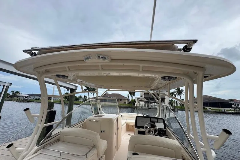 Slide: The Image of 2020 Grady-White Freedom 285 boat interior with helm, docked by waterfront homes. - 46
