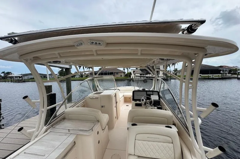 Slide: The Image of 2020 Grady-White Freedom 285 boat interior with helm, seating, and water view. - 47