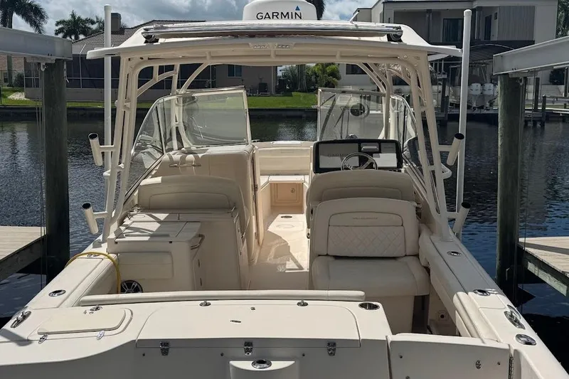 Slide: The Image of 2020 Grady-White Freedom 285 boat docked, featuring spacious seating and Garmin navigation. - 48