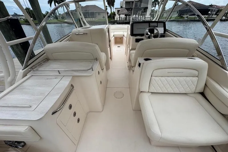 Slide: The Image of 2020 Grady-White Freedom 285 boat interior with luxurious seating and steering console. - 49
