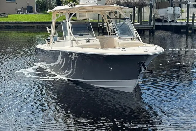 Slide: The Image of 2020 Grady-White Freedom 285 boat on calm water, featuring sleek design and modern amenities. - 5