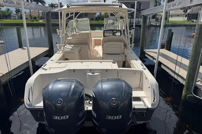 Slide: The Image of 2020 Grady-White Freedom 285 boat with dual Yamaha 300 engines docked by the water. - 53
