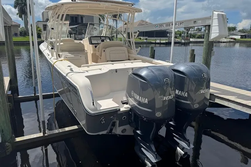 Slide: The Image of 2020 Grady-White Freedom 285 boat with twin Yamaha 300 engines docked by waterfront. - 55