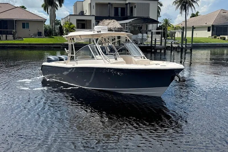 Slide: The Image of 2020 Grady-White Freedom 285 boat on calm water near waterfront homes. - 7