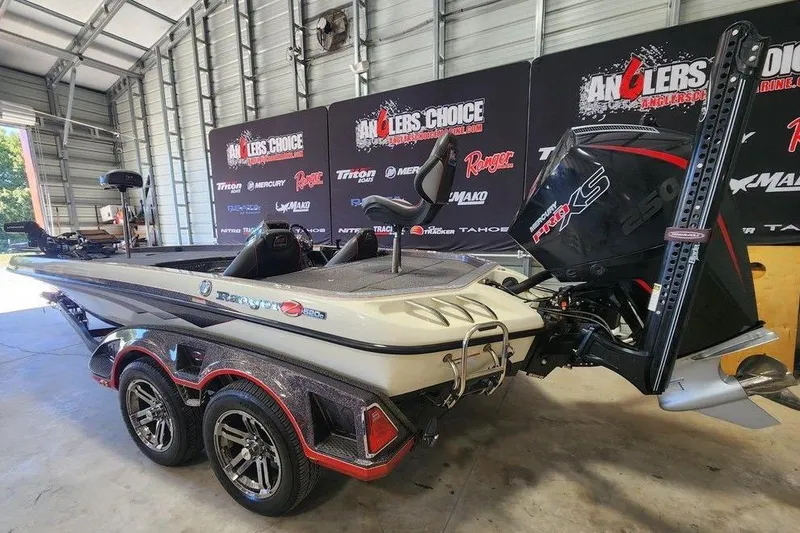 Slide: The Image of 2021 Ranger Z520C Ranger Cup Equipped boat in showroom, featuring dual axle trailer. - 5