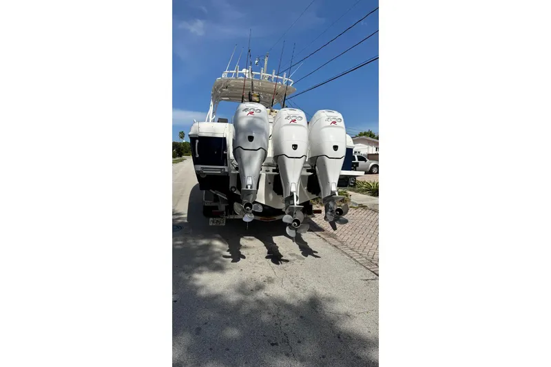 Slide: The Image of 2006 Intrepid 377 Walkaround boat with triple outboard engines on a sunny day. - 4
