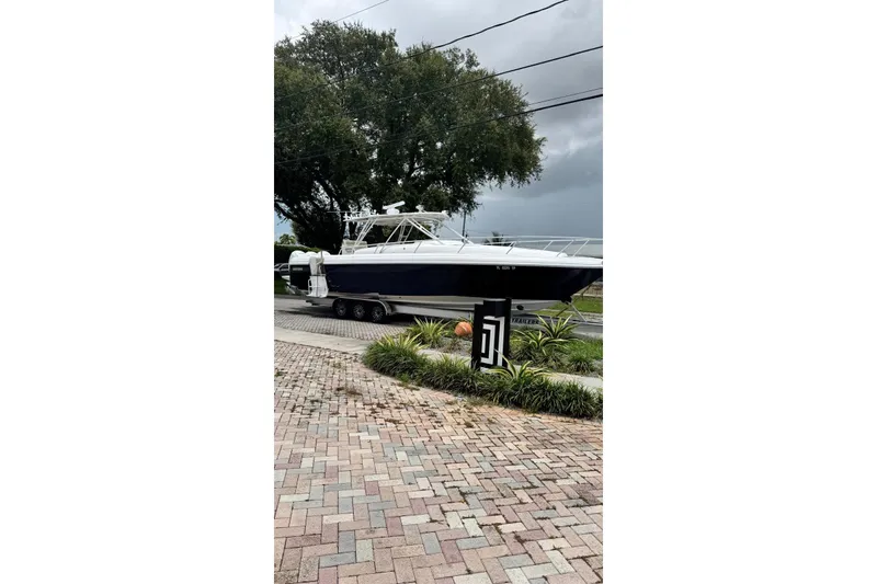 Slide: The Image of 2006 Intrepid 377 Walkaround boat on trailer, parked on brick driveway. - 5