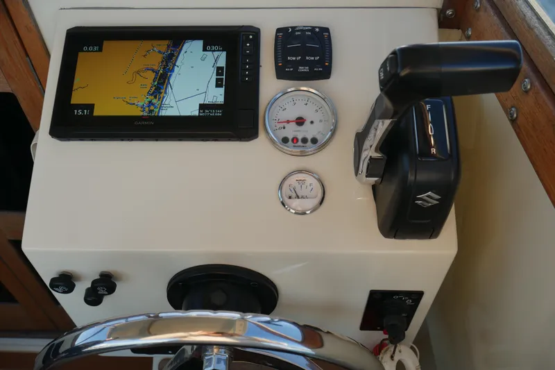 Slide: The Image of 2023 Seaway 24 Seafarer dashboard with Garmin GPS, Suzuki controls, and gauges. - 11