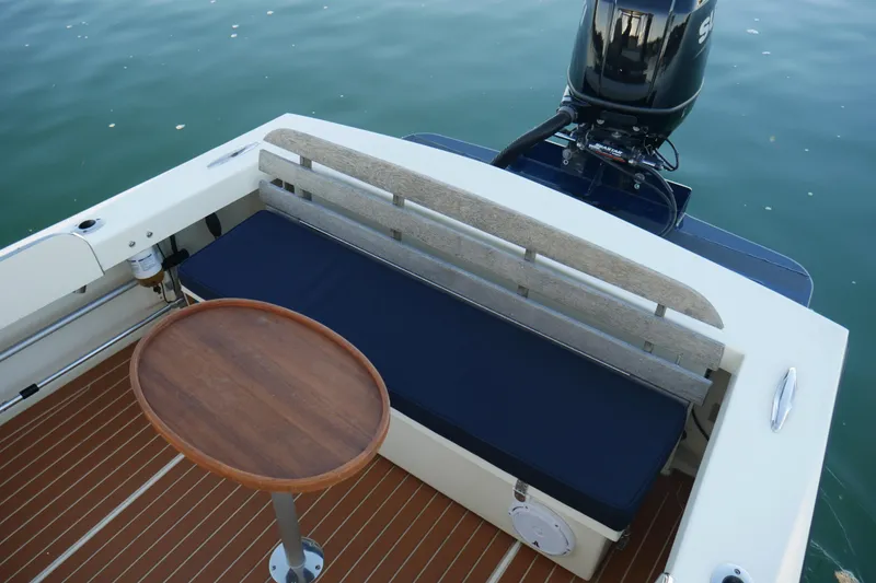 Slide: The Image of 2023 Seaway 24 Seafarer boat interior with wooden table and cushioned seating. - 16