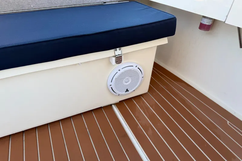 Slide: The Image of 2023 Seaway 24 Seafarer boat interior with cushioned seat and speaker. - 17