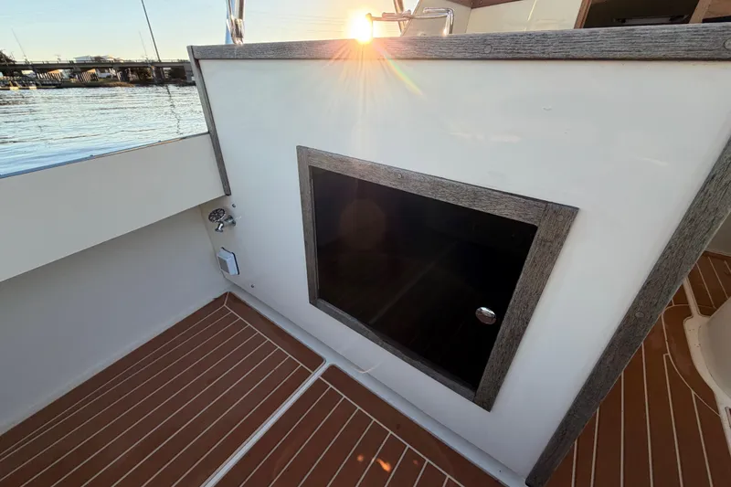 Slide: The Image of 2023 Seaway 24 Seafarer boat interior with wooden flooring and sunset view. - 18