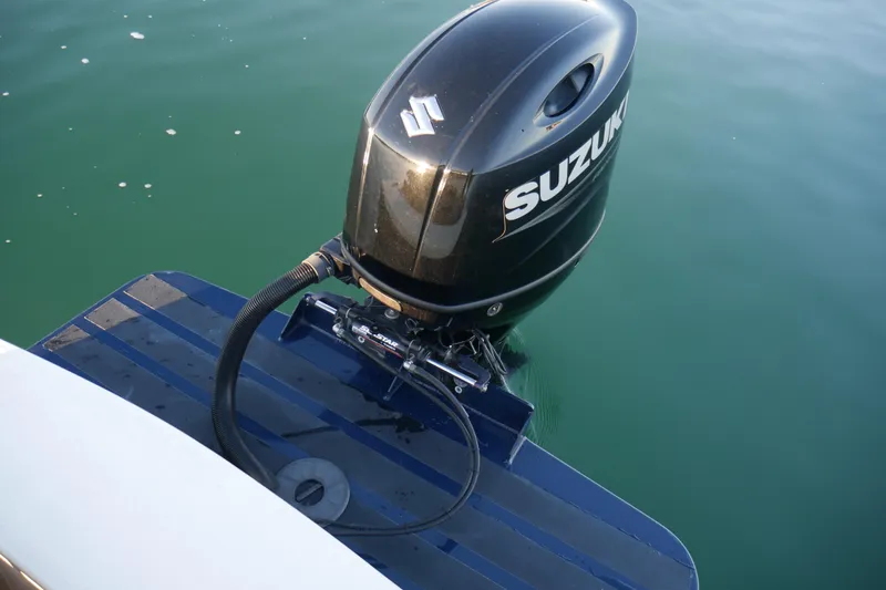 Slide: The Image of Outboard motor on 2023 Seaway 24 Seafarer boat in calm water. - 19