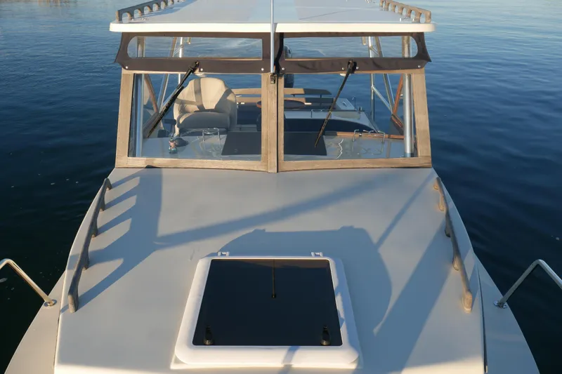 Slide: The Image of 2023 Seaway 24 Seafarer boat on calm water, showcasing cabin and deck. - 21