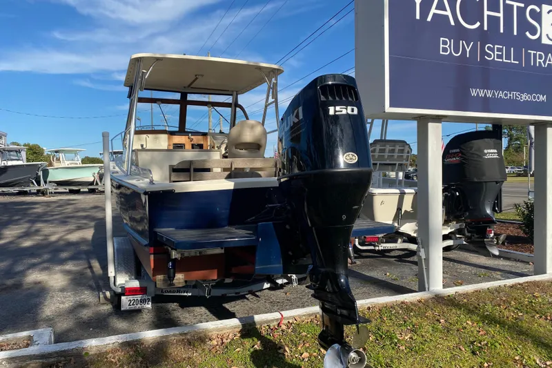 Slide: The Image of 2023 Seaway 24 Seafarer boat on calm water, rear view with outboard motor. - 3