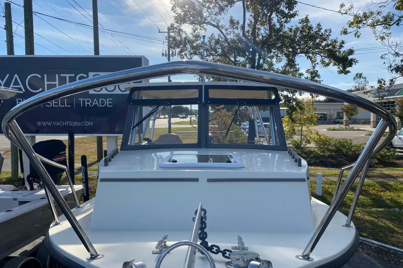 Slide: The Image of 2023 Seaway 24 Seafarer boat on calm water, featuring a Suzuki outboard motor. - 4