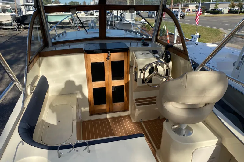 Slide: The Image of 2023 Seaway 24 Seafarer boat with Suzuki outboard motor on calm water. - 5