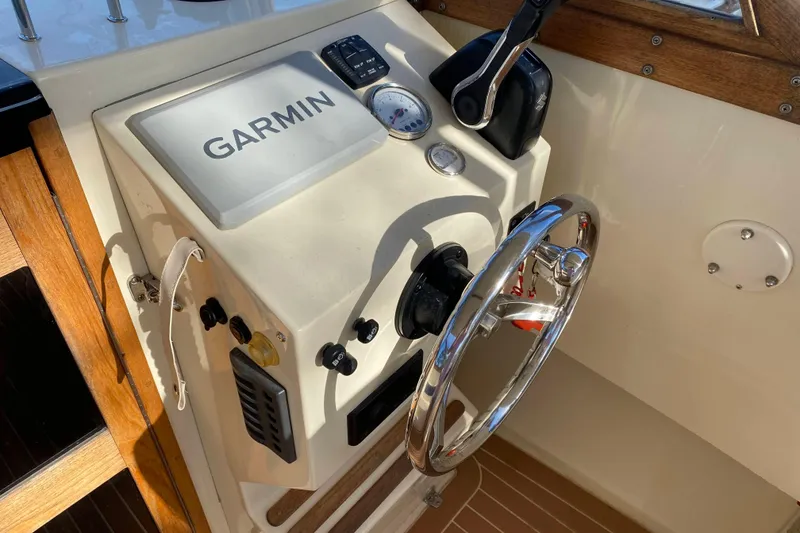 Slide: The Image of 2023 Seaway 24 Seafarer boat with Suzuki outboard engine on calm water. - 6