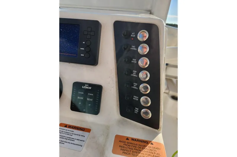 Slide: The Image of Control panel of 2020 Robalo 246 Cayman boat with switches and Lenco trim tab controls. - 10