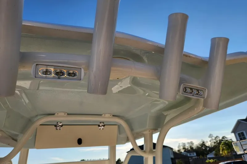 Slide: The Image of 2020 Robalo 246 Cayman boat T-top with rod holders and LED lights. - 13