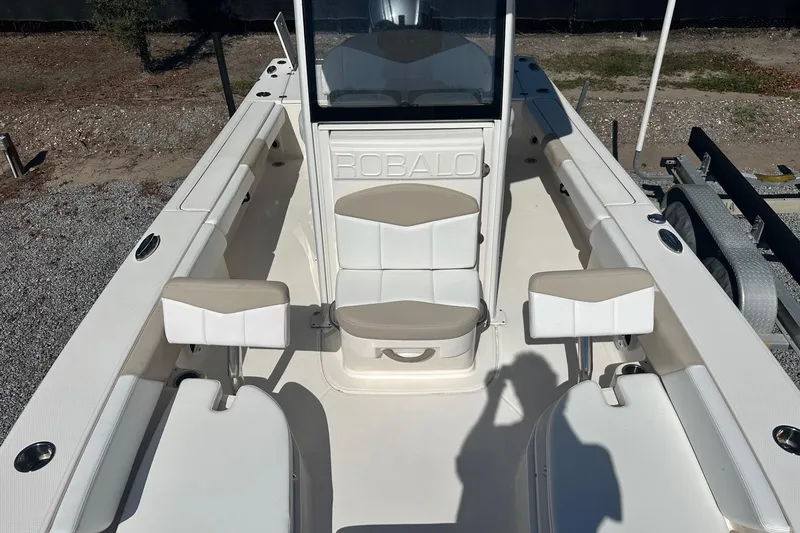 Slide: The Image of 2020 Robalo 246 Cayman boat interior with white seating and console. - 15