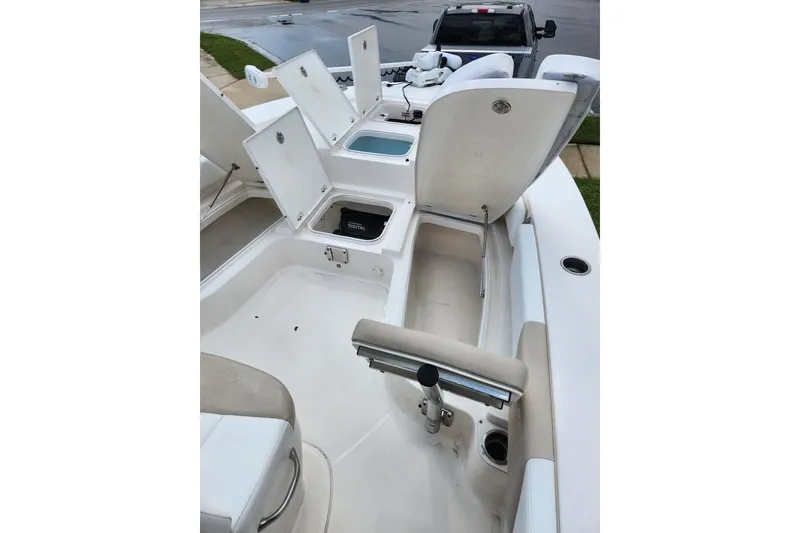 Slide: The Image of 2020 Robalo 246 Cayman boat interior with open storage compartments and seating. - 16