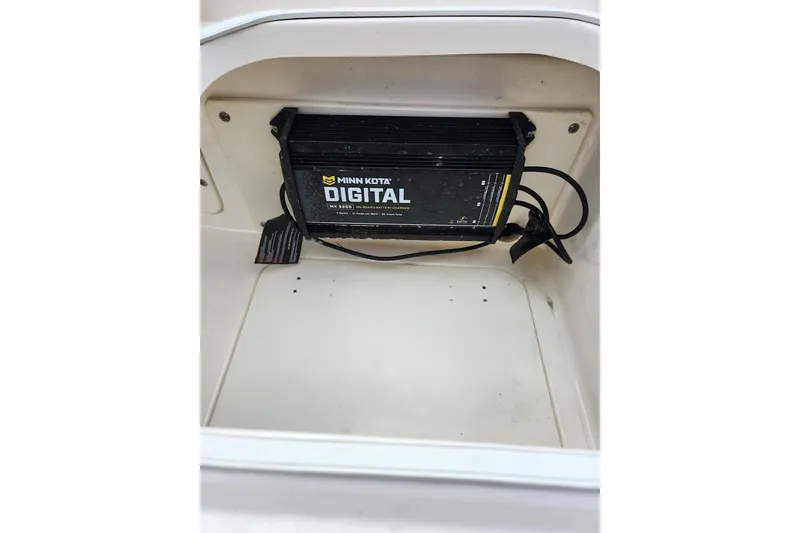 Slide: The Image of Minn Kota digital charger inside 2020 Robalo 246 Cayman boat compartment. - 18