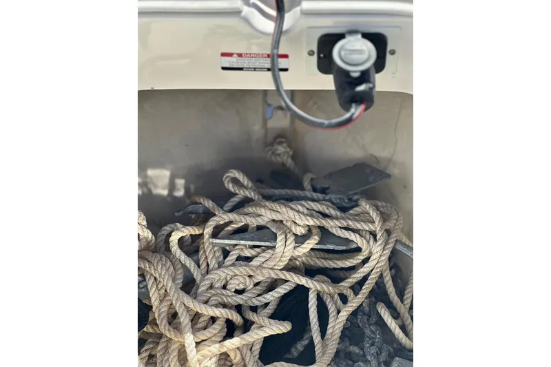Slide: The Image of Robalo 246 Cayman 2020 boat anchor compartment with ropes and chains. - 19