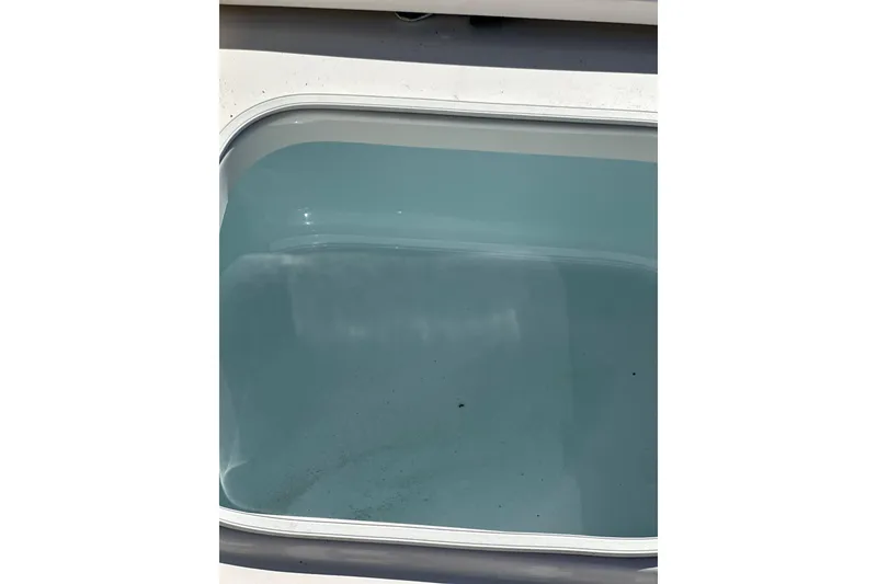 Slide: The Image of Livewell on 2020 Robalo 246 Cayman boat, filled with water. - 23