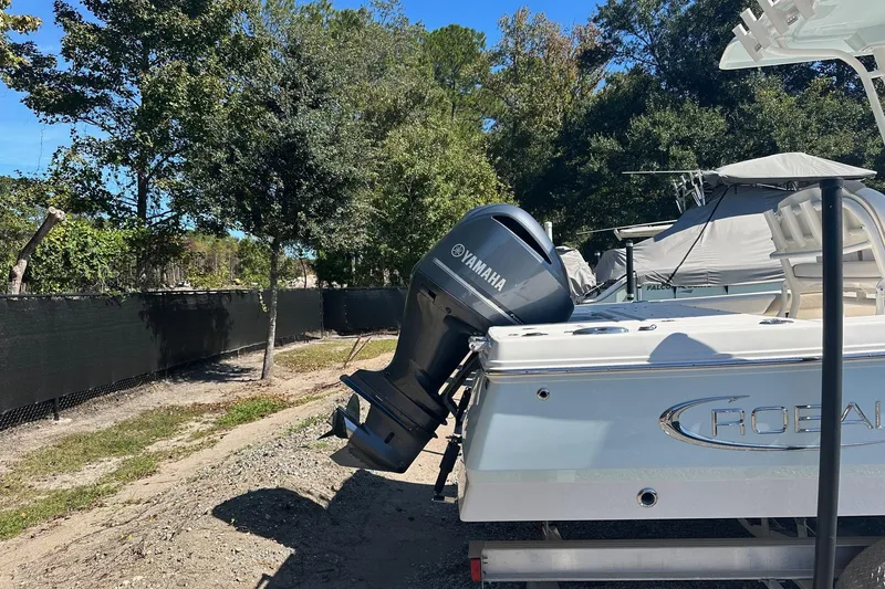 Slide: The Image of 2020 Robalo 246 Cayman boat with Yamaha outboard motor, parked outdoors. - 4