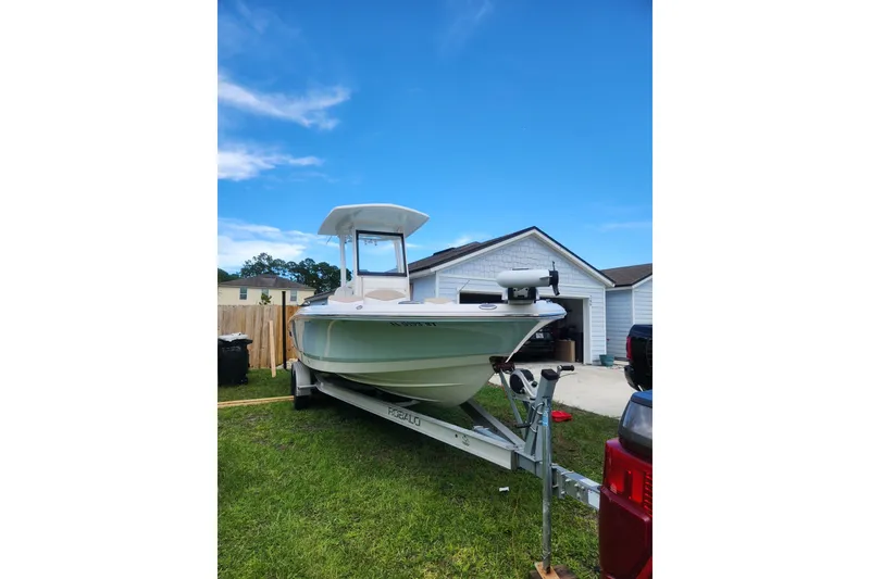 Slide: The Image of 2020 Robalo 246 Cayman boat on trailer in residential driveway. - 5