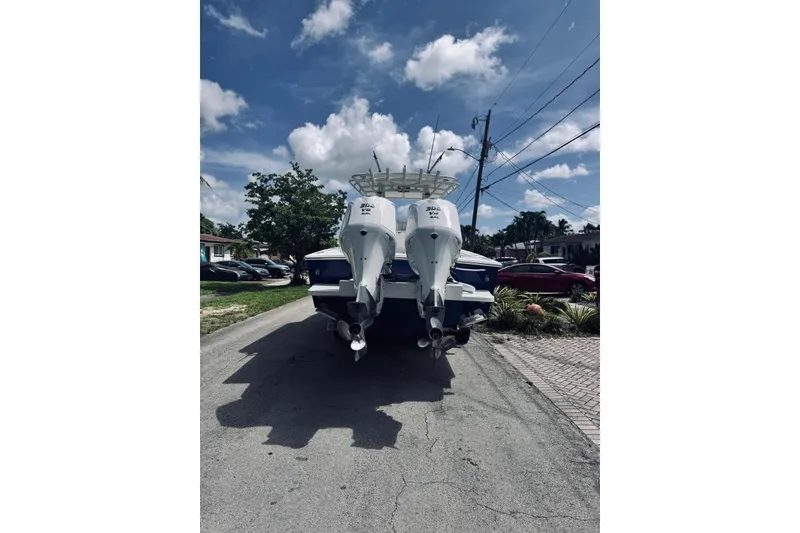 Slide: The Image of 2005 Jupiter 31 boat with dual engines parked on a residential street. - 12