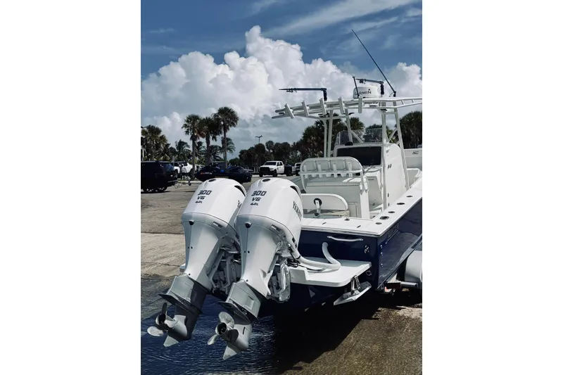 Slide: The Image of 2005 Jupiter 31 boat with twin Yamaha 300 V6 outboard engines at a dock. - 2