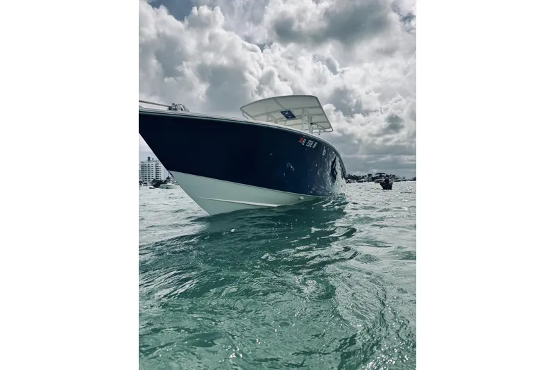 Slide: The Image of 2005 Jupiter 31 boat on water under cloudy sky. - 8