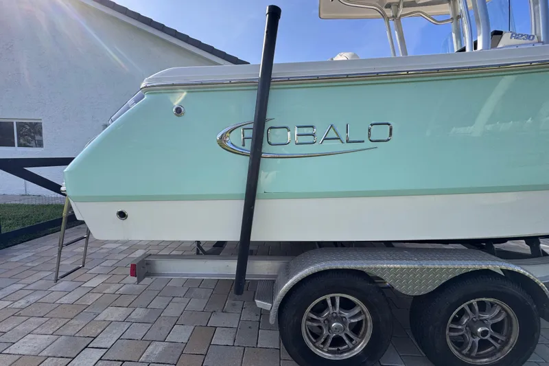 Slide: The Image of 2022 Robalo R230 Center Console boat on trailer, side view. - 12