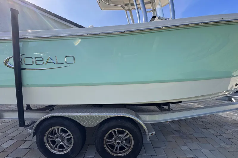 Slide: The Image of 2022 Robalo R230 Center Console boat on a trailer, side view. - 13