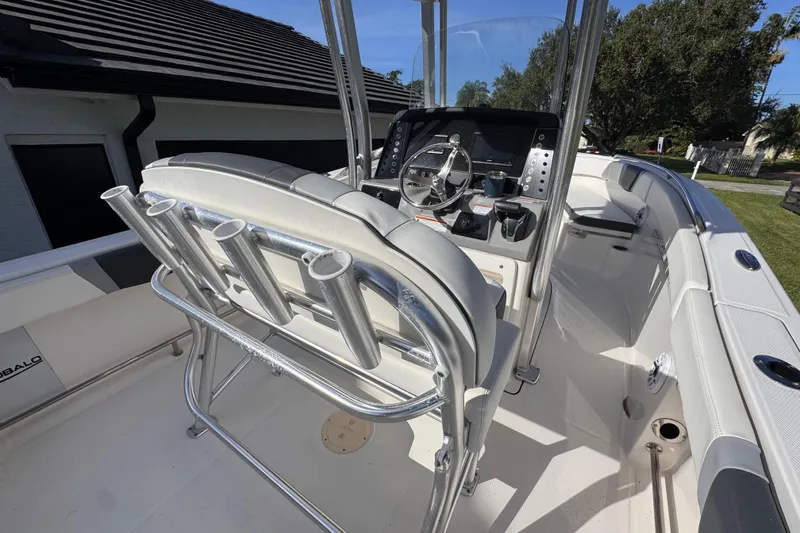 Slide: The Image of 2022 Robalo R230 Center Console boat interior with helm, seating, and rod holders. - 20