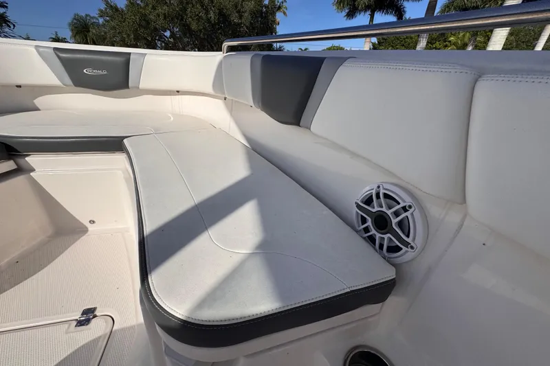 Slide: The Image of 2022 Robalo R230 Center Console boat interior with cushioned seating and speaker. - 23