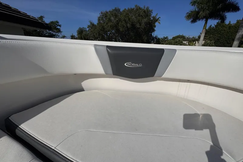 Slide: The Image of 2022 Robalo R230 Center Console boat interior with cushioned seating and logo. - 24