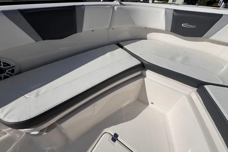 Slide: The Image of 2022 Robalo R230 Center Console boat seating area with cushioned benches. - 26