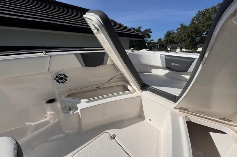Slide: The Image of 2022 Robalo R230 Center Console boat interior with open storage compartment. - 27